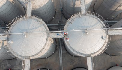 Aerial view of large white industrial storage tanks