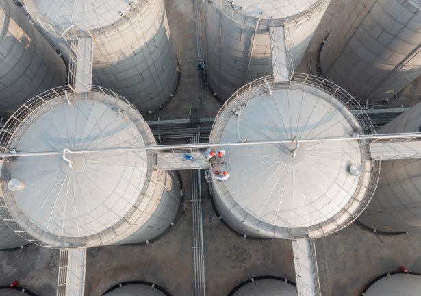 Aerial view of large white industrial storage tanks