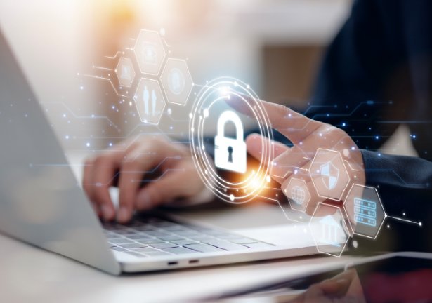 Person using laptop with digital padlock icon representing cybersecurity.