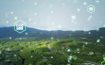 An aerial view of a lush green landscape overlaid with digital icons representing sustainability, energy efficiency and environmental data. An aerial view of a lush green landscape overlaid with digital icons representing sustainability, energy efficiency and environmental data.