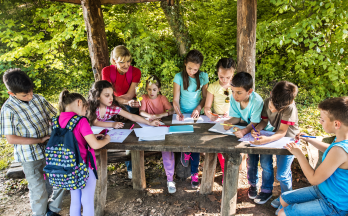 scc-kids-field-trip-colouring Des enfants colorient à l’extérieur pendant un voyage scolaire