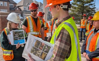 Assessment team reviewing urban forestry guidelines during a site visit.