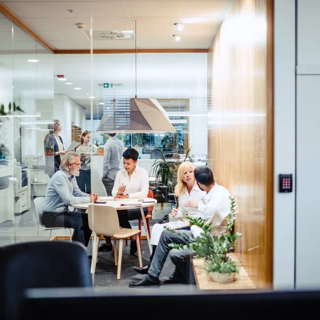 Team of four collaborating in a modern meeting room