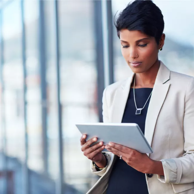 Professional woman looking at an iPad.