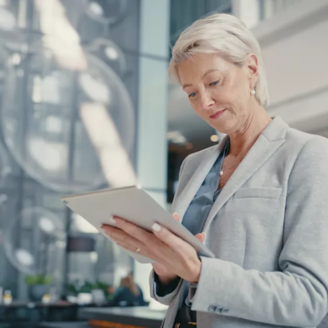 Woman executive looking at tablet in an office.