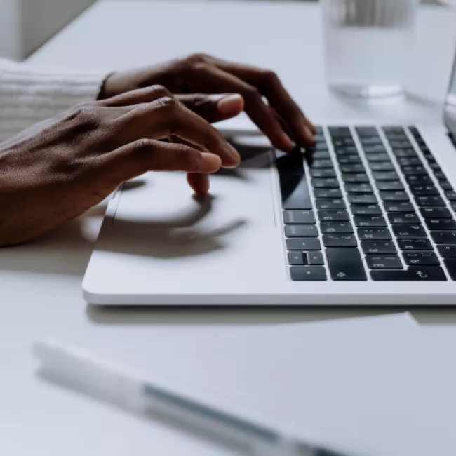 person typing on laptop