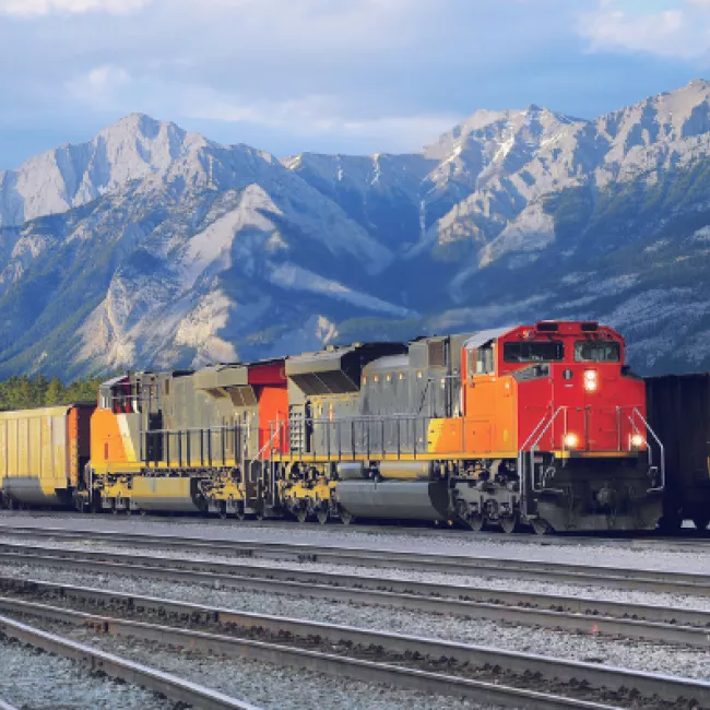 train on track in front of mountains