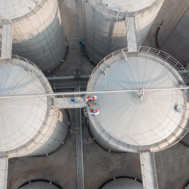 Aerial view of large white industrial storage tanks