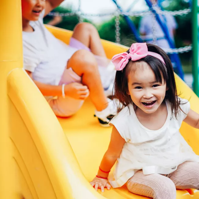 Girl going down slide