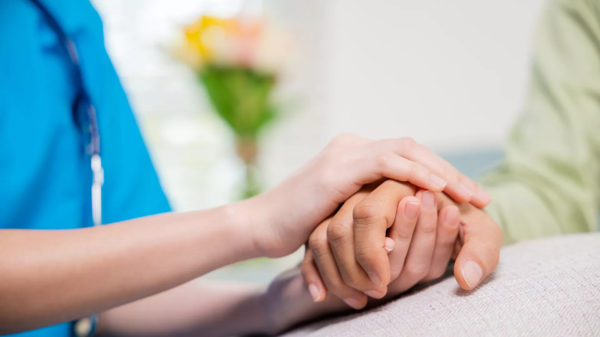 Nurse holding patients hand