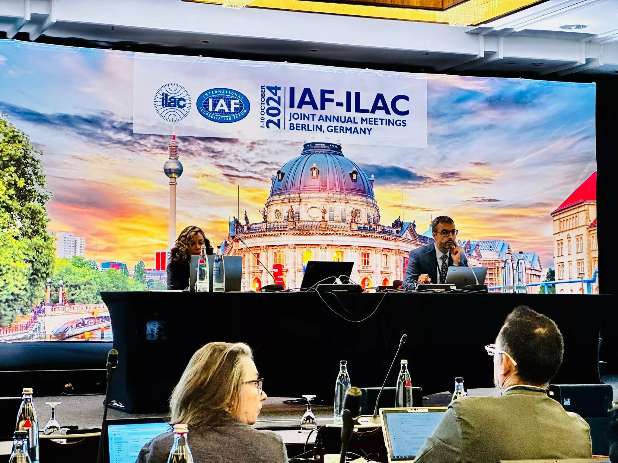 Abdel Kassou co-chairs a digital transformation working group at the IAF-ILAC Joint Annual Meetings in Berlin, Germany, with a backdrop of the Berlin skyline.